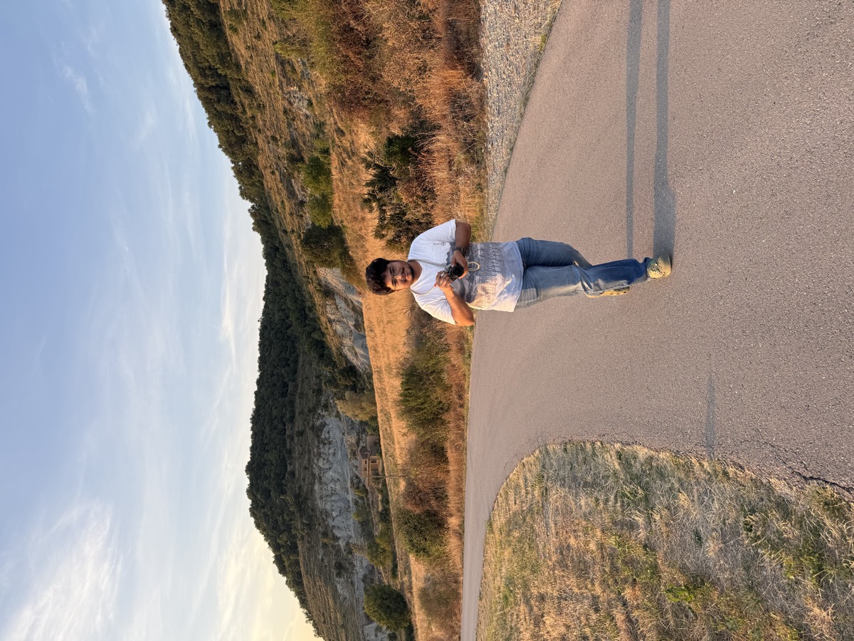 Asmit walking a quiet mountain road on the way down